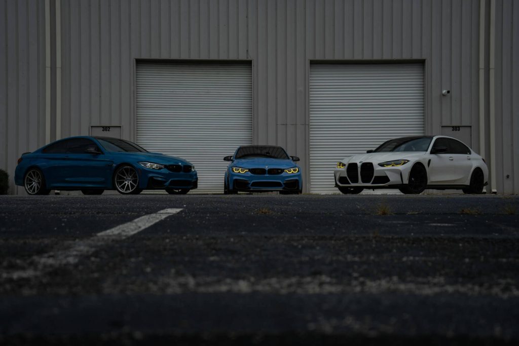 three bmws before garage doors